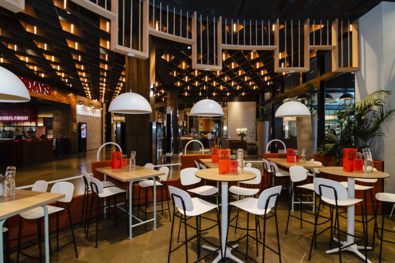 A Wide angle interior view of a Modern Restaurant dining area of Fonda in Chadstone. The space features a wide variety of seating arrangements, with high top and standard height tables.