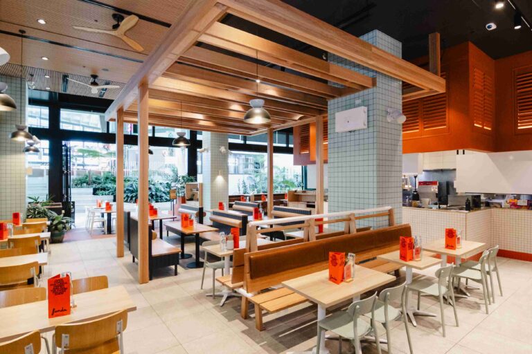 Fonda Chadstone Restaurant Fitout with 2 seated and 4 seated long brown tables with white chairs