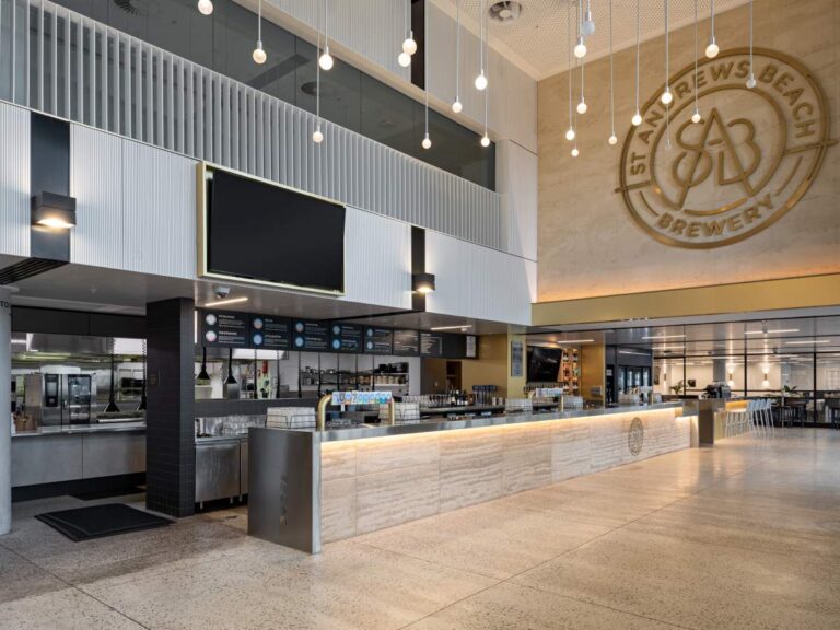 Bar fitout by Shape Shopfitters with custom joinery and branded signage feature wall at St Andrews Beach Brewery Melbourne